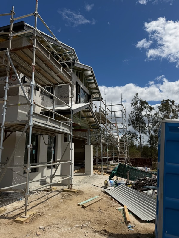 Scaffold wrap around a wrapped residential shell